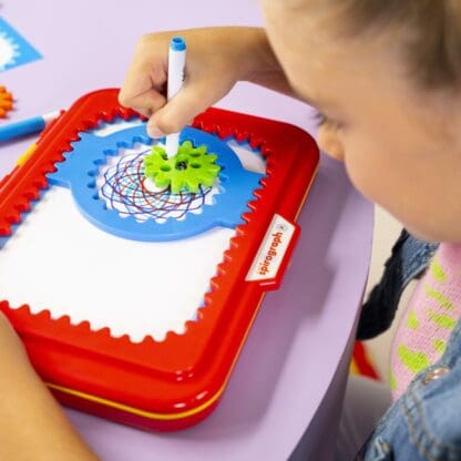 Close-up of Girl drawing with Spirograph Jr.