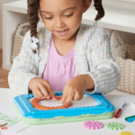 Girl using Spirograph Jr Bluey