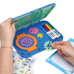 Hand placing pieces in the storage compartment of Spirograph Jr Bluey